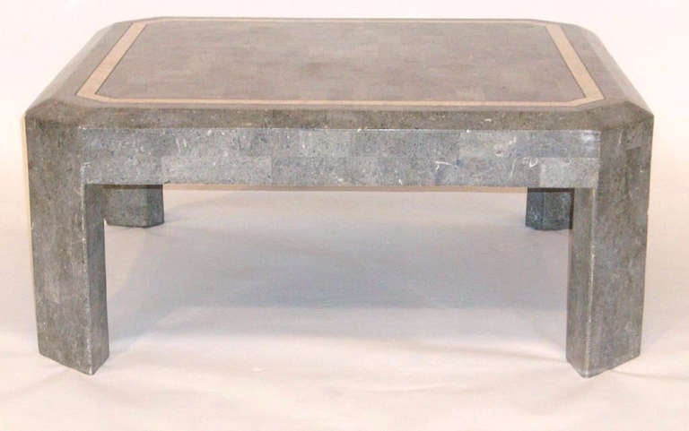 A vintage coffee or cocktail table in tessellated grey stone with cream toned stone inlay border

Reduced from: $1,550
