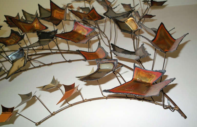 A vintage wall mounted brutalist mixed metal sculpture depicting oak leaves in brass, stainless steel and copper. The piece is signed Curtis Jere and dated 1978
