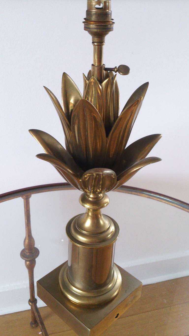 A vintage French brass table lamp by Maison Charles with lotus petal details surrounding the socket.
unless as shown on picture, the lamp has been rewired for the US + features US bulb socket