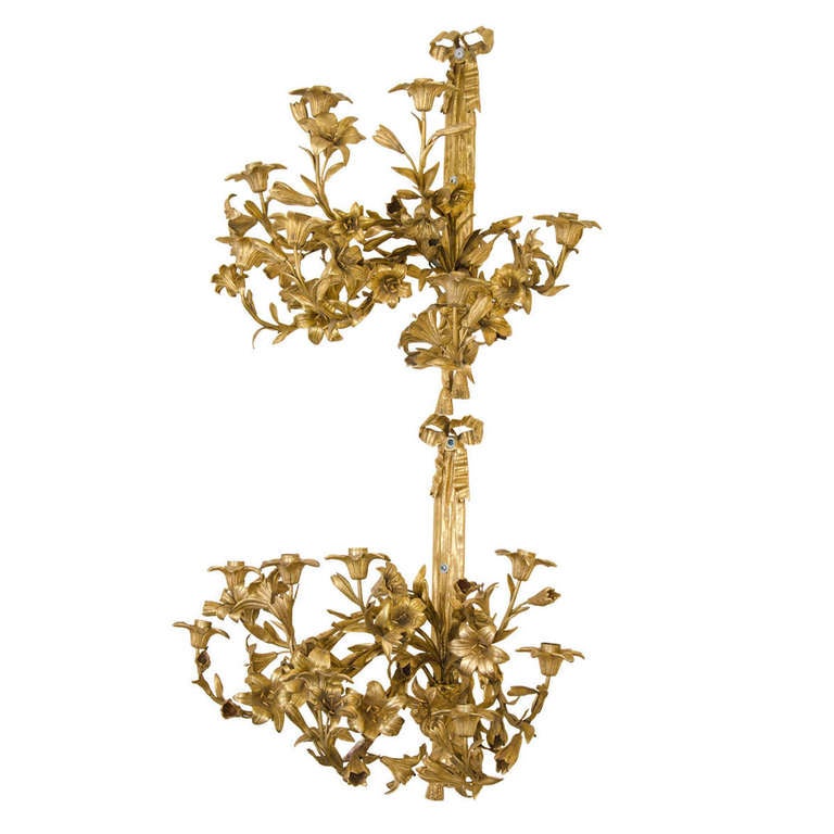 Large late 19th century pair of gilded bronze candelabra wall sconces with bow and floral motif.

Good condition with some wear to gilt.

Reduced from: $9,500