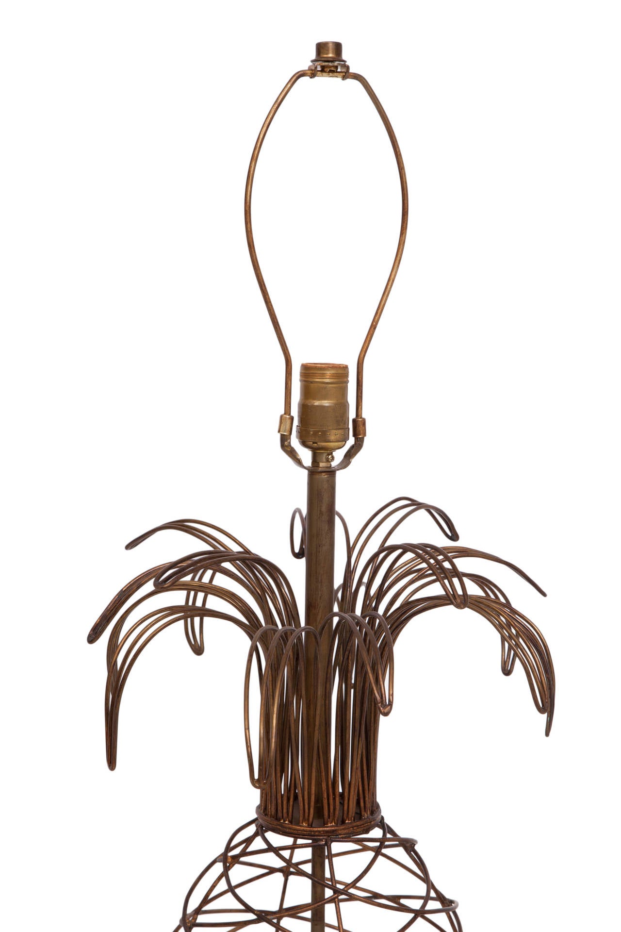 A pair of vintage, sculptural table lamps, produced circa 1970s, each with soldered metal wires, worked into the form of a stylistic pineapple, surrounding the central stem, on a curved cylinder base; harp included. Wiring and sockets to US