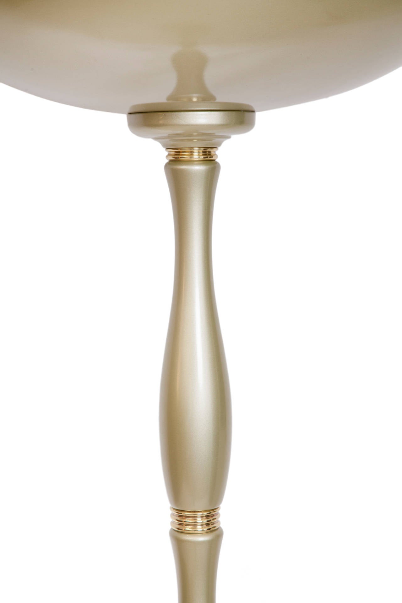 A vintage torchiere floor lamp, produced circa 1950s, in soft gold tone, with large domed shade over a long baluster formed stem, inset by brass banding, on a circular base. Includes Brazilian standard N plug. Very good vintage condition, consistent