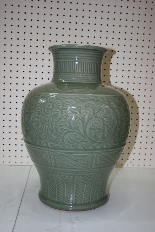 Japanese porcelain vase in light celadon color with baluster form carved peony design. Signed.

3877