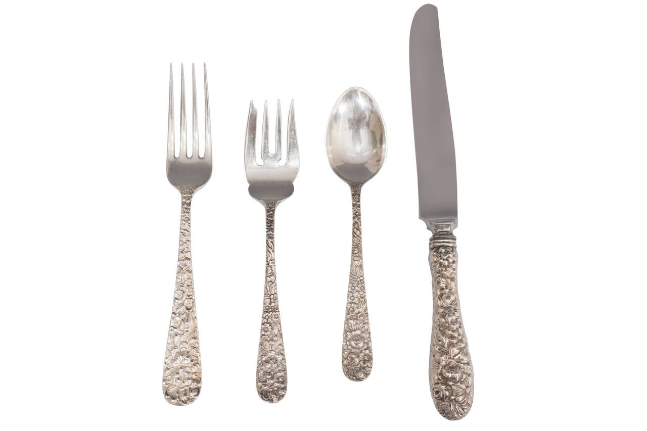 A set of 24 forks, knives, dessert forks and spoons by the Stieff Co in a Repoussé style rose pattern. Marked The Stieff Co., stainless steel, sterling handle. There are also 11 service pieces.

Measurements and weight upon request.