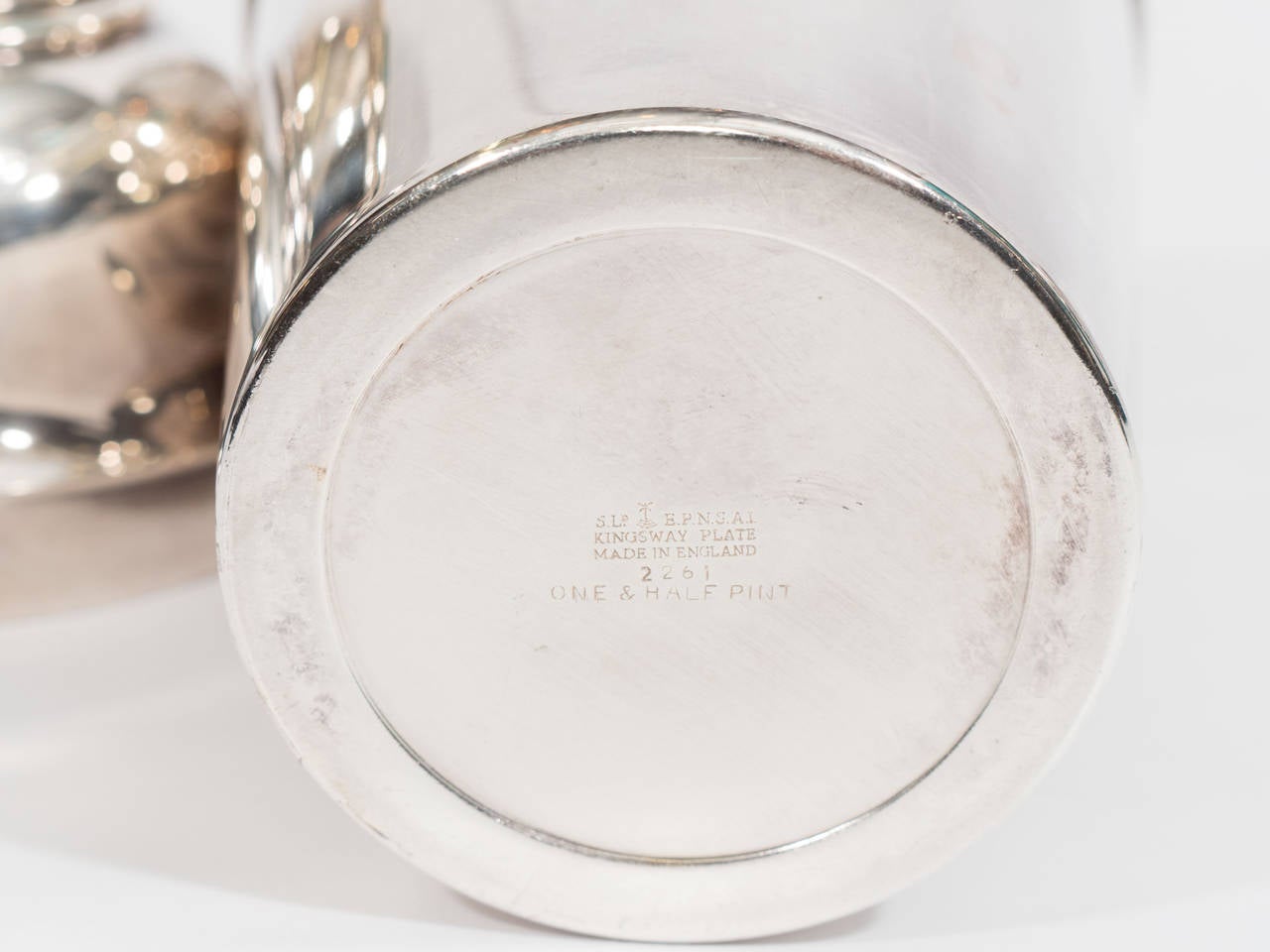 A vintage English silver plate cocktail shaker with lemon squeezer. Marked Kingsway plate; one and a half pint shaker.

Good vintage condition with age appropriate wear.