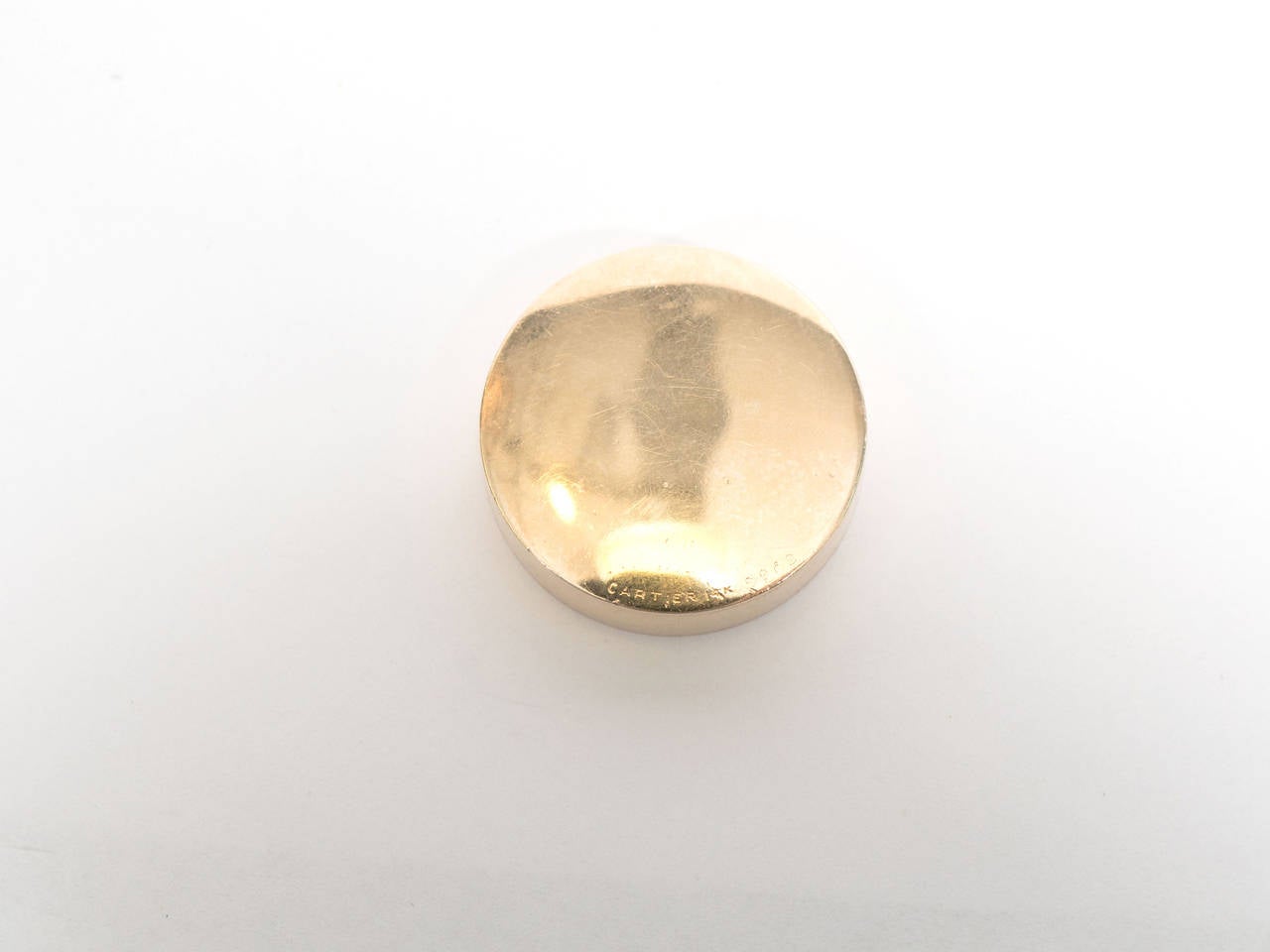 A vintage 14-karat gold circular design pill box with pull ring. Can also be used as a pendant. Marked Cartier on the bottom.

Good vintage condition with age appropriate wear. A few light scratches.