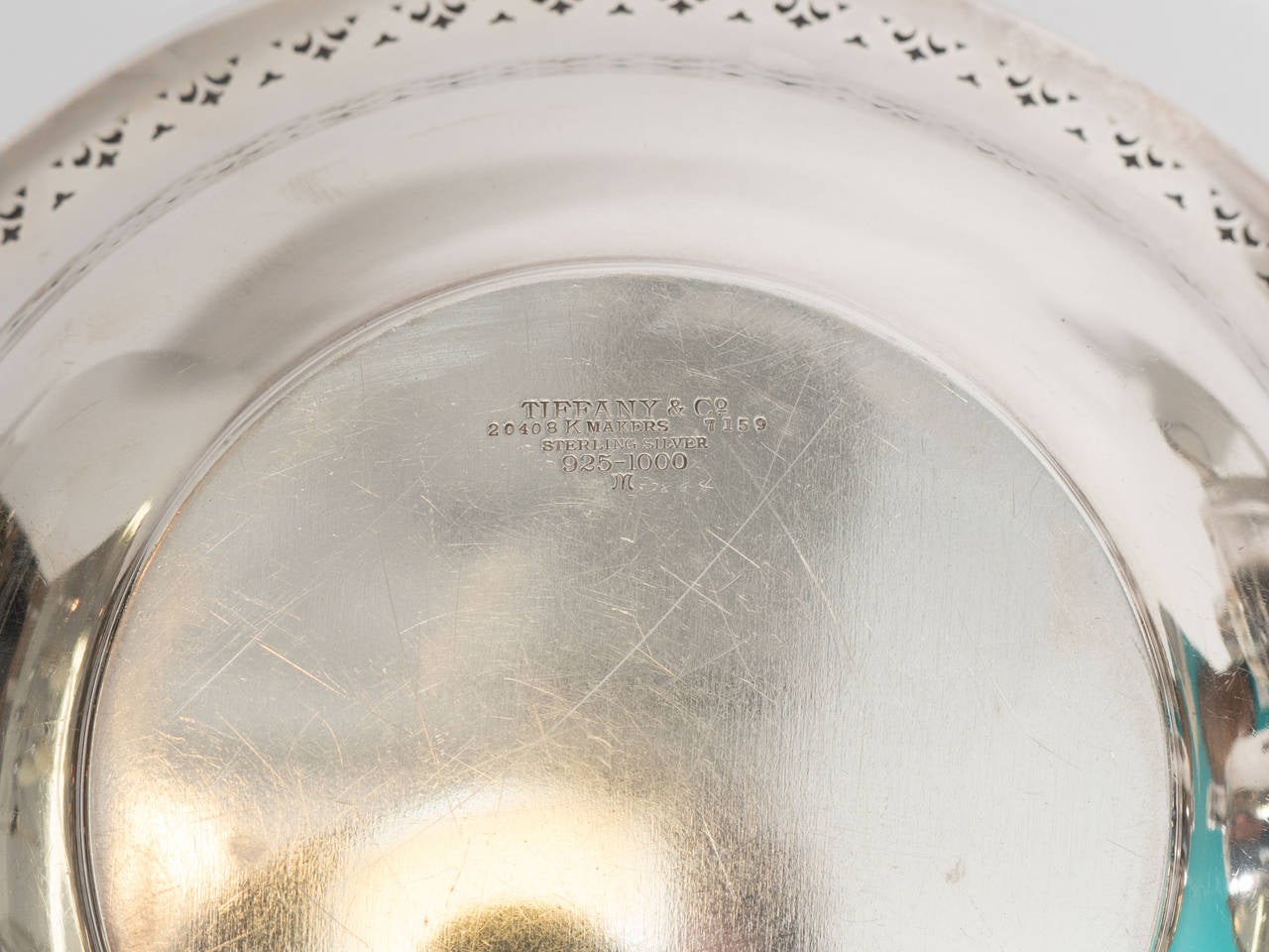 An antique sterling silver pierced edge bowl engraved with initial 