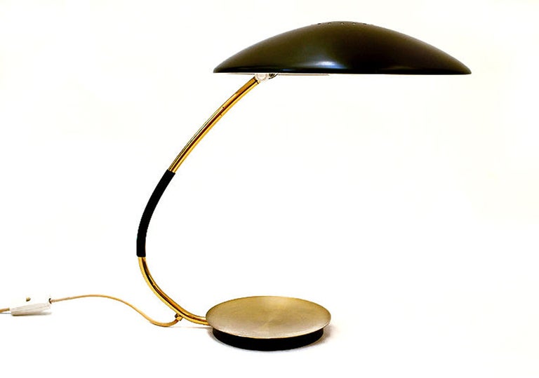 Modernist brass body desk lamp with saucer shaped black enamel shade. The head swivels for directional light. By Christian Dell for Kaiser Idell of Germany. The piece is in good vintage condition with age apprpriate wear; some scratches to enamel