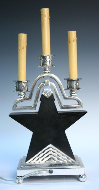 Rare modernist Art Deco star lamps in silvered bronze and black marble with three candelabra style sockets each. Inscribed crest underneath base. Very heavy and substantial great design period lamps.