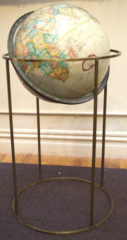 A distinctive floor globe on brass stand created by Paul McCobb with cartography by LeRoy M Tolman, the noted cartographer who worked as Chief Cartographer for Replogle Globes, Inc. during the 1950s and 1960s. This handsome floor globe will add an
