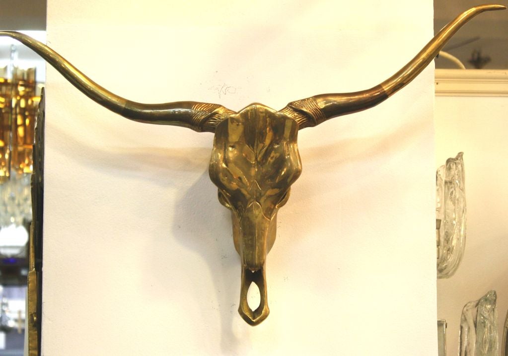 Mid Century lifelike brass hanging sculpture of a longhorn steer skull.

4081