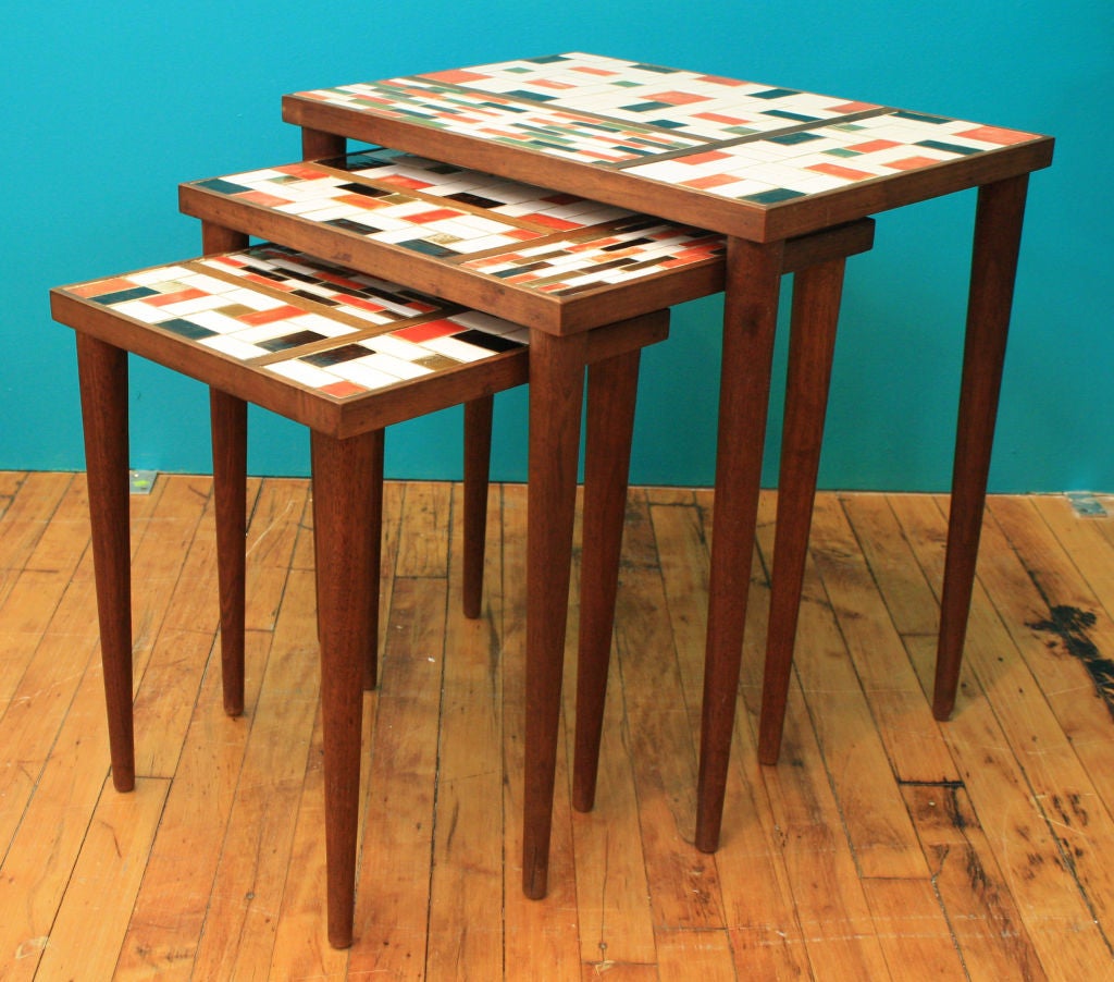 Danish modern stackable end tables with orange, white, black and brass tiles inset in a Mondrian inspired design.<br />
<br />
Large Table:   21.5