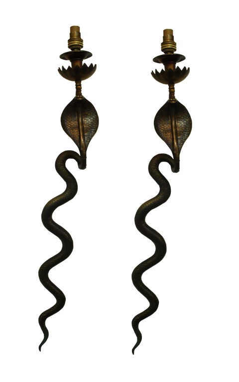 This elegant pair of old, Art Deco, bronze, cobra sconces was designed in France in the 1930's. They are highly detailed and beautifully patinated and have been rewired for American use.