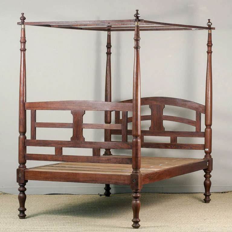 Anglo-Indian solid rosewood four poster bed with canopy. Headboard has gently curved top rail with square section rails. Footboard has slighted peaked top rail. Fits full size mattress.