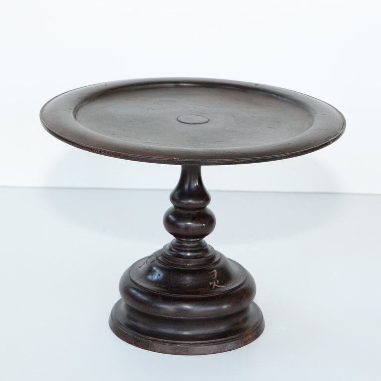 Beautifully turned hardwood pedestal from the Chinese Vietnamese border. Writing etched in on base of stand.