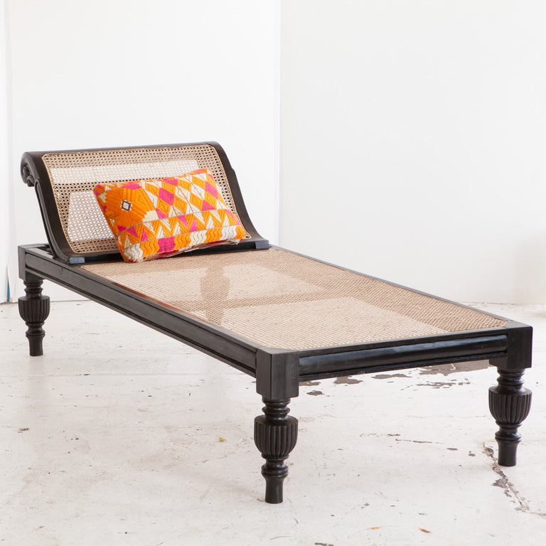 Very rare solid ebony daybed with gently curved head board and continuously caned seat. Side rails have a concave carved profile. Headboard angle is adjustable. Legs are turned in an urn style typical of the period.

seat height = 16.75