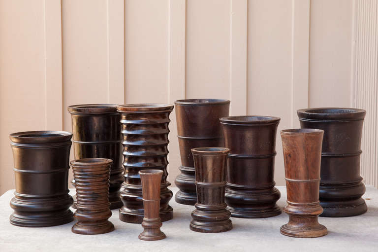 Set of ten beautifully turned hardwood brush pots from the border of Vietnam and China. 