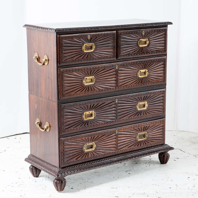 Indo-Portuguese rosewood campaign chest with sunburst carving on drawer fronts. Top and bottom separate with carrying handles on the side. There are 2 drawers on top row followed by three big drawers.