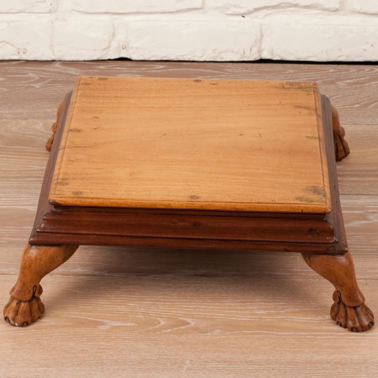 Anglo-Indian footstool made of teak, rosewood and satinwood with carved wood feet.