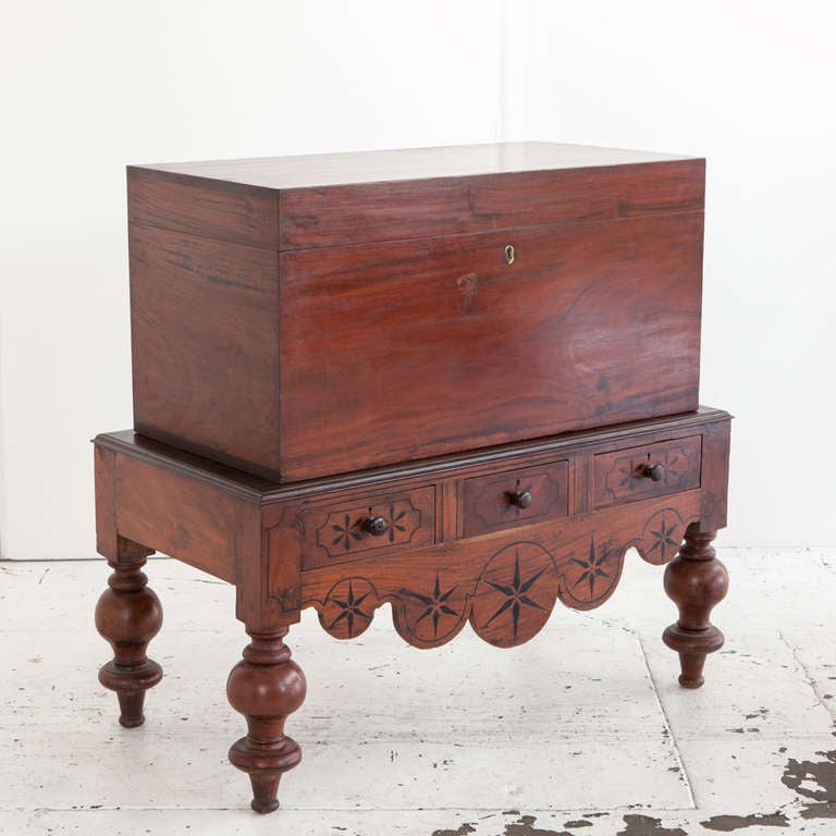 Anglo-Indian style trunk made from single planks of mahogany. Inside has document storage compartment. Sits on base with three drawers with ebony inlay.

Table dimensions: 43.5