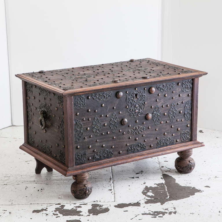 A very special Dutch storage chest of solid plank construction in jackfruit. The chest and feet are covered with elaborately formed brass mounts. The Chest rests on ball feet typical of the Dutch style. Two large brass hinges with pierced finials