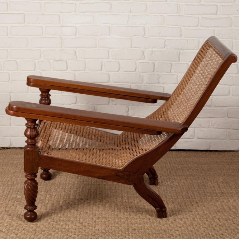 Anglo-Indian teak plantation chair with folding arms. Turned front legs, brass hange detail, newly caned seat.