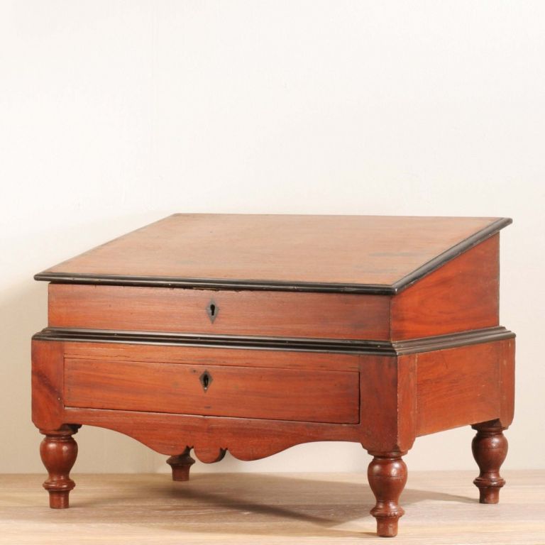 Anglo-Indian munim desk or accountants desk, designed to be used while sitting on the floor. Made of solid jackfruit with ebony details, top opens to reveal compartments as well as a secret panel for cash storage. Single drawer in front has more