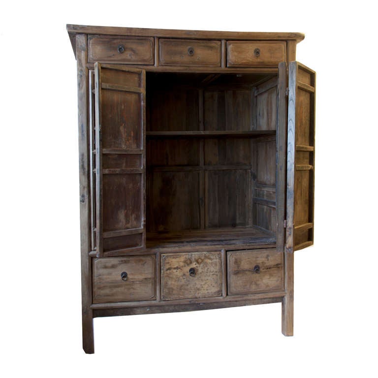 This wardrobe is made of Elm Wood and is from the Shanxi province of China.
It has three large drawers on the bottom and three drawers on the top of the cabinet.  The four doors are hinged so that they open all of the way.