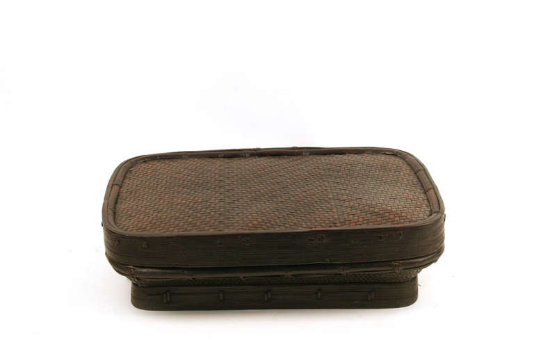 This woven bamboo box with flat lid is from the Philippines.  It is hand-woven out of rattan with a bamboo frame. Great size for letters and papers.