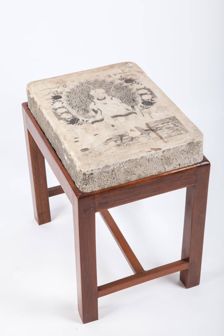 Side table made from an old lithographed stone from India depicting a scene from the Hindu book of scriptures on newly made teak base. The stone is from the early 20th century. 

I have many others as well. 