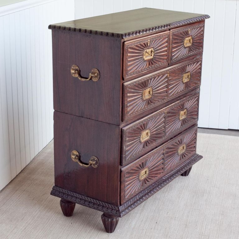 Carved rosewood Campaign chest. Top and bottom separate with original carrying handles on the side. There are two drawers on top row followed by three big drawers on the bottom. The sunburst pattern on the drawer front is typical of Indo-Portuguese