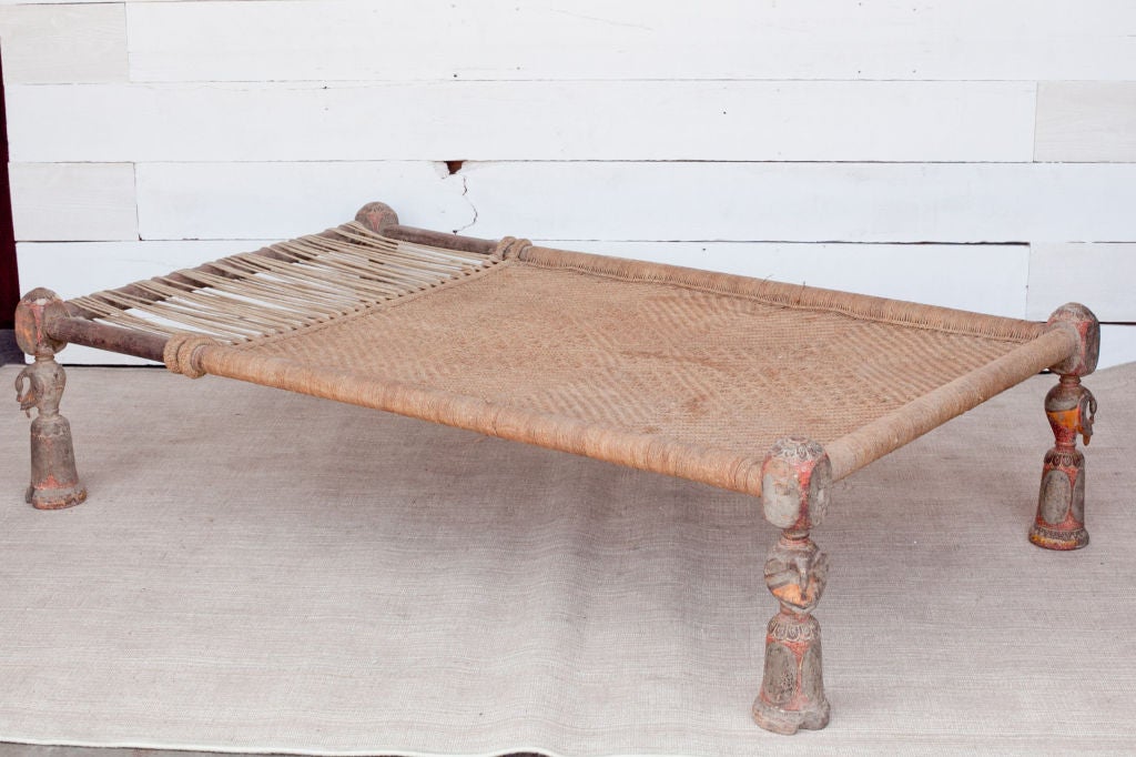 Very traditional Indian daybed called a charpoy with stylized carved peacock legs. Original condition. Makes a great coffee table or daybed.