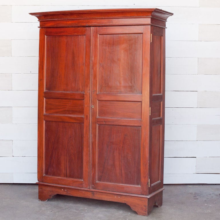 Dutch Colonial solid jackfruit wood armoire; jackfruit is a very dense tropical hardwood that is naturally rot and insect resistant. Armoire breaks down flat for transport. Single brass lock. Beautiful clean lines. Great for extra storage.