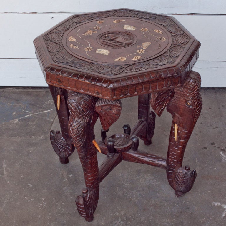 Anglo-Indian solid rosewood octagonal side table with stylized carved elephant head legs and bone tusks. Carved wood top has bone inlay in floral motif.