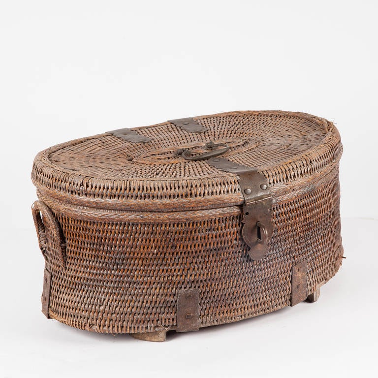 Rattan lidded basket with rattan side handles and brass hardware from Southern India.