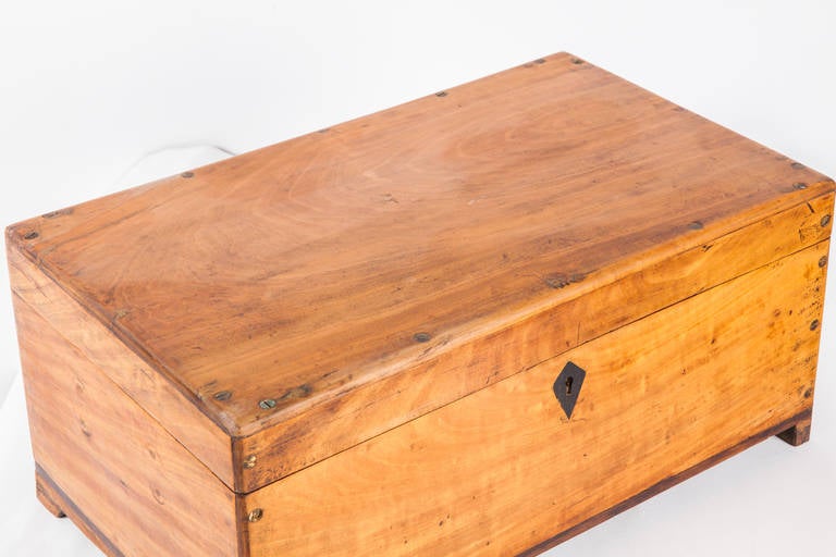 Anglo-Indian style box made of solid satinwood with ebony escutcheon used by merchants for storing cash and documents. Brass screw head details are evident on the top and sides. The inside has many compartments.
