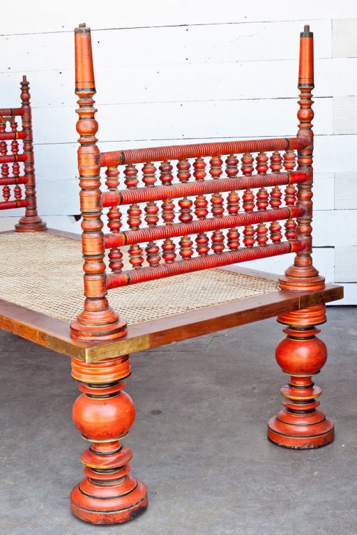 Rarely available, large hand-painted wooden daybed from southern India with newly caned seat. Sides are removable, protective brass corners.