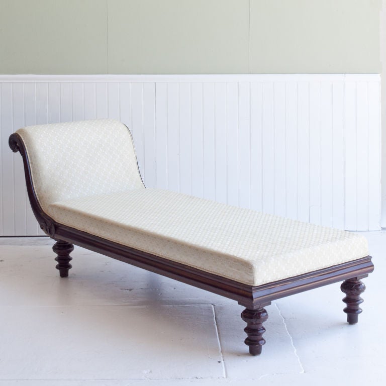 Anglo-Indian daybed with mahagony wood frame and newly upholstered seat and back. Bed frame rests on turned wood legs.