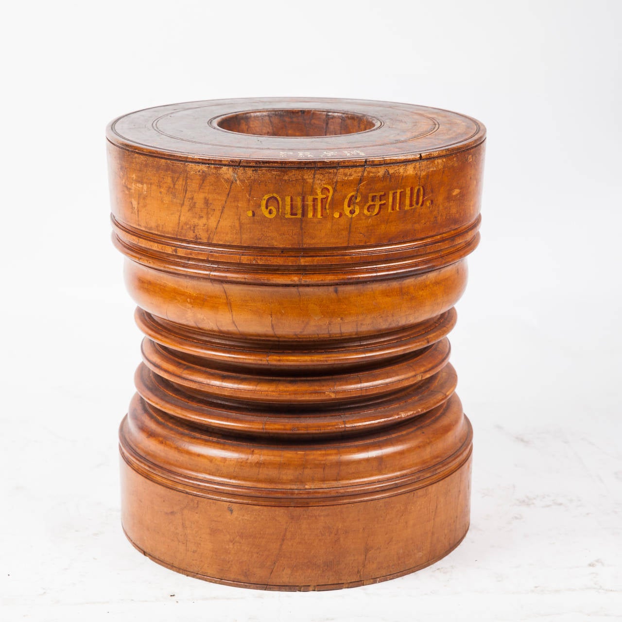 Solid satinwood rice grinder from Southern India. Rice was poured into top concavity and pounded into flour using a heavy wooden pole. Wonderful paint details. Excellent patina. Makes great low side table and decorative object. We do have ones that