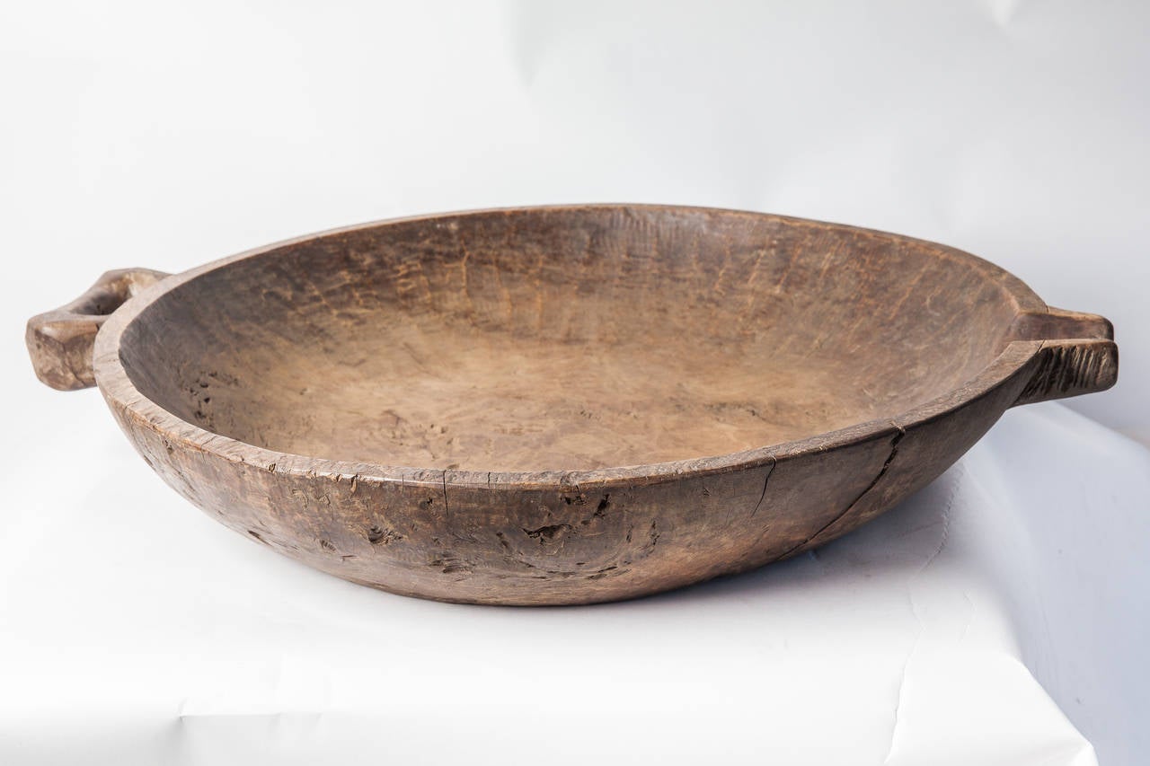 Wood bowl from the Philippines with wood handle and spout.