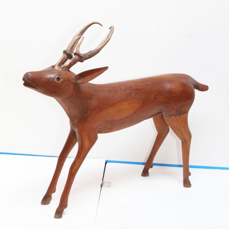 Solid teak deer from Indonesia with carved facial detail and real deer horns.