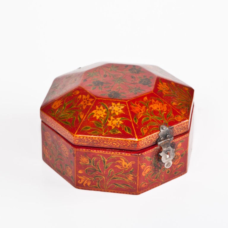 Small Indo-Portuguese box with Mughal Indian lacquer work on the octagonal form, each panel depicting a different flower typical of the 17th c. Emperor Shahjahan and Emperor Jahangir floral patterns, silver mountings, the interior in crimson red