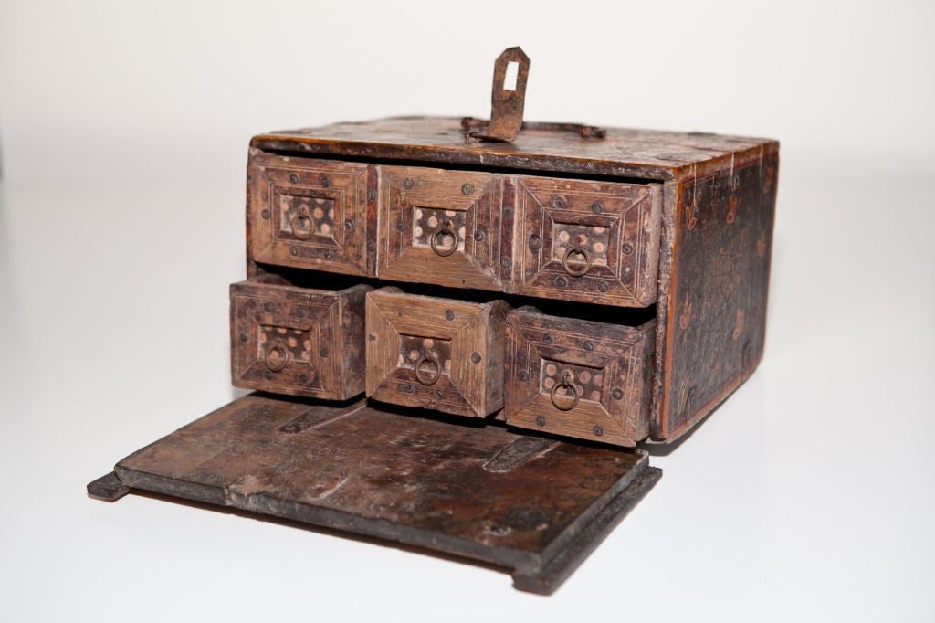 Indo-Portuguese contador box, late 18th c., the teakwood Indian Mughal lacquer box profusely decorated with flowering foliates on the face and top, a cow, tiger, and horse painted on each of the other sides, forged iron carrying handle, bindings and