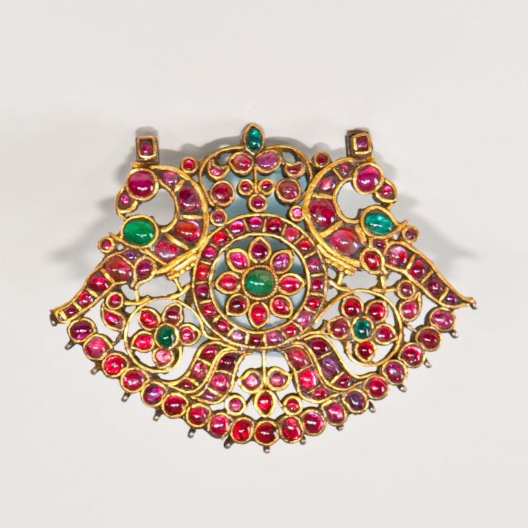 Fine gold and silver gem set pendant, South India, 19th c., 24kt gold top side with elaborate kundan work set with rubies and emeralds, forming stylized bird and foliate patterns, base in silver,  50.8 grams (inclusive of gemstones)
