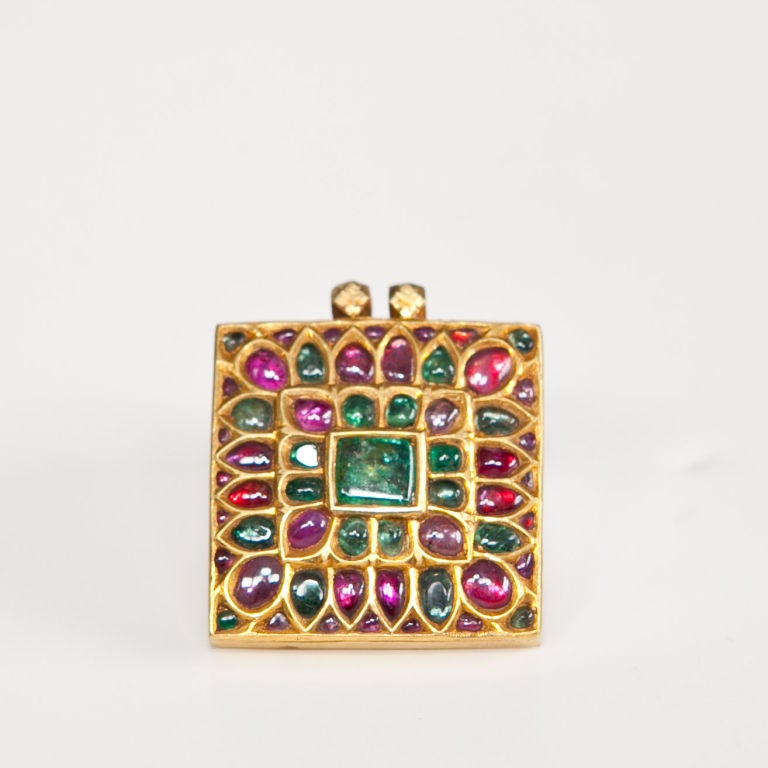 Mughal 24kt gold gem set pendant of squared form, gold kundan work set with rubies and emeralds, fitted in a leather box,  30.8 grams (inclusive of stones)