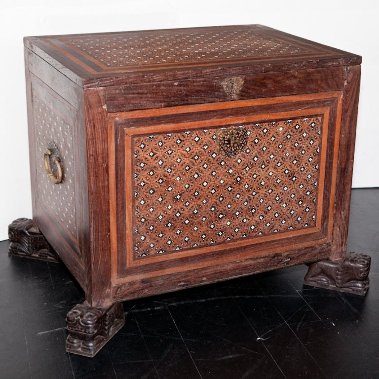 An Indo-Portuguese contador from the 18th century. It is made from rosewood with padouk, ebony and ivory inlay. The contador has an opening at the top and also a fall front opening at the bottom to reveal a set of drawers inside. It has a typical