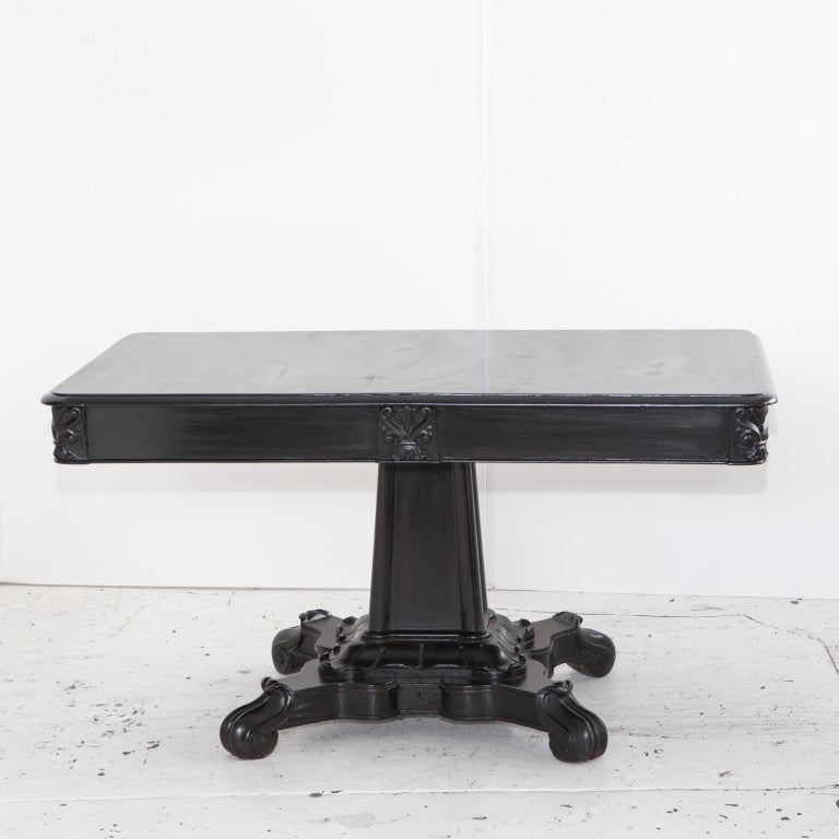 Ebonized Anglo-Indian center or library table with 2 drawers. Carved details on corners of table top and sides.