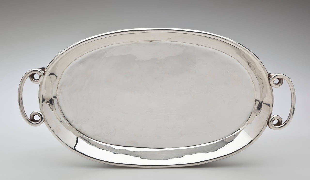 An ovoid tray with two scrolled handles by William Spratling (1900-1967). The small sterling silver tray is perfect for serving espresso or hors d'oeuvres. It is a rare example of Spratling's work. It is hallmarked with the conjoined WS and marked