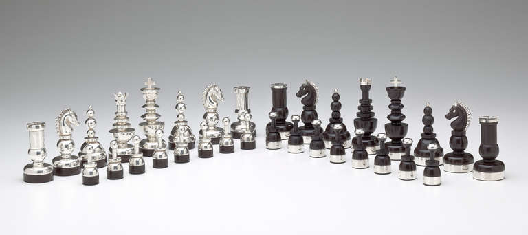 A rare chess set by Mexican designer Hector Aguilar (1905 - 1986).  The 32 piece set is made of alternating 16 pieces in sterling silver; 16 pieces in rosewood.  The 4