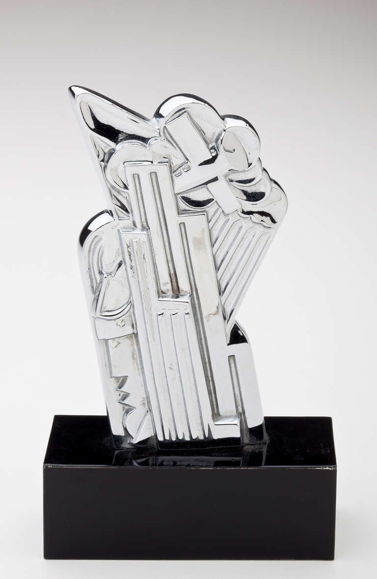 An abstract sculpture by Pop Artist Roy Lichtenstein in chromium plated copper.  Lichtenstein titled the sculpture, 